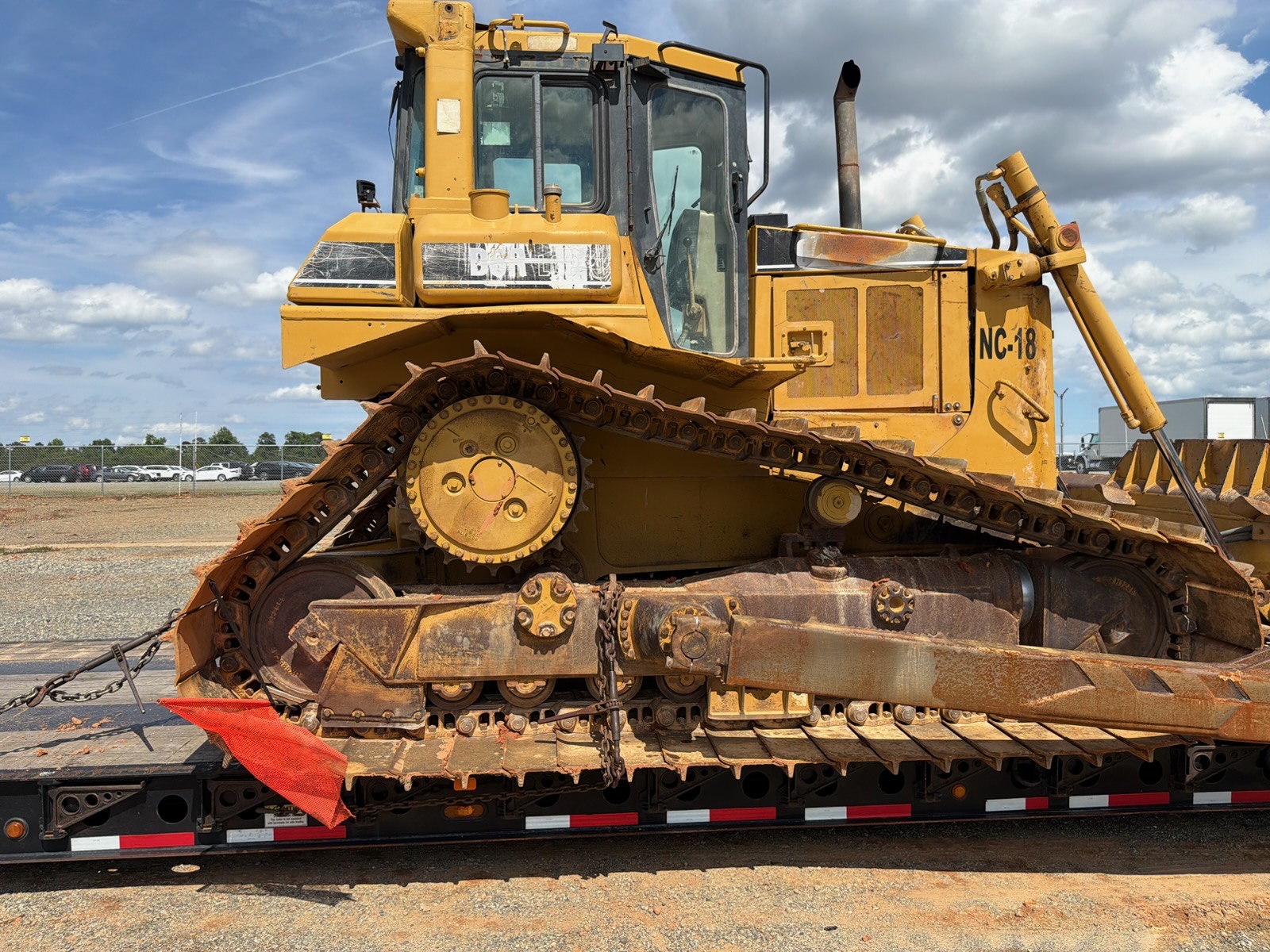 Caterpillar dozer secured on a flatbed for transport