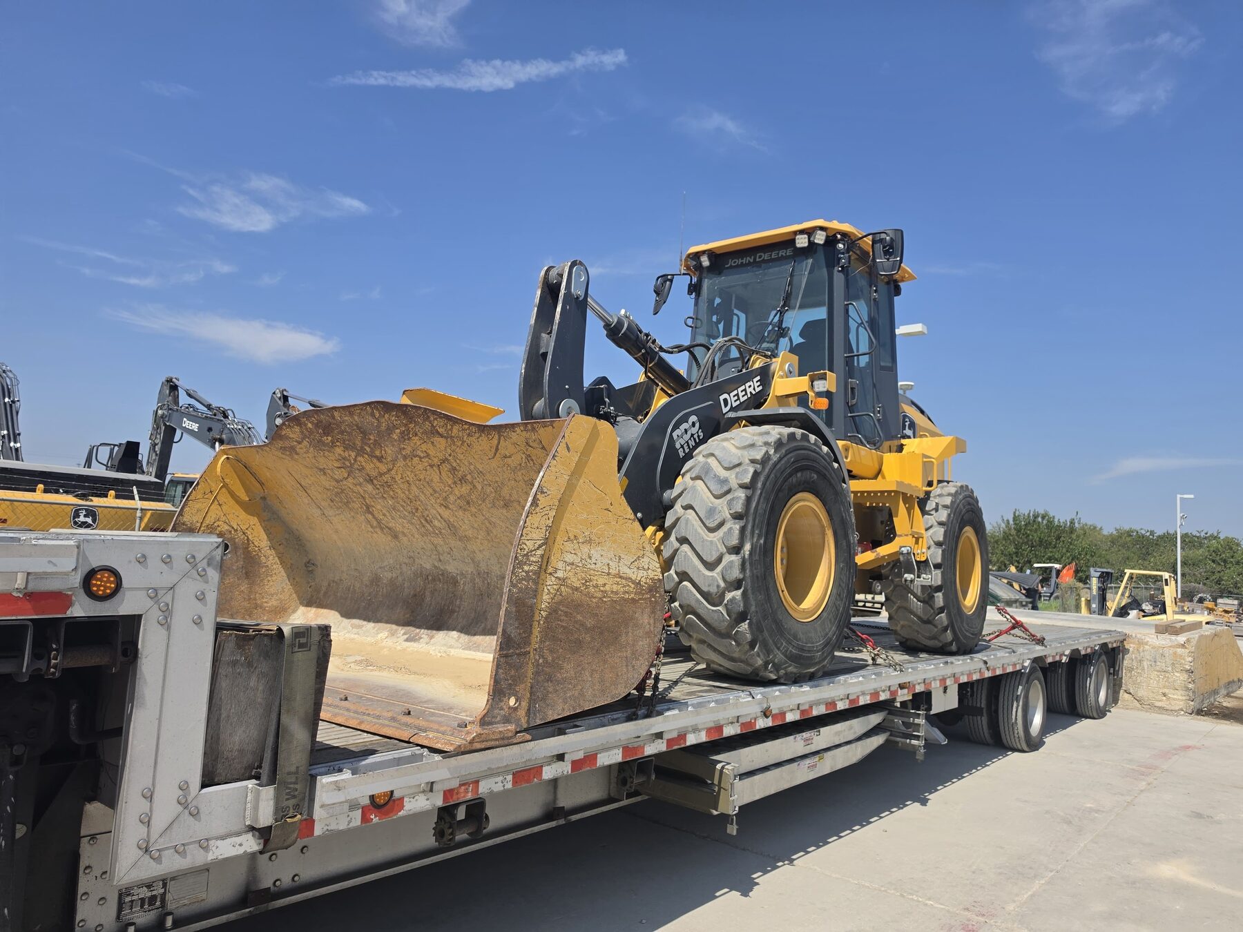 John Deere wheel loader on a flatbed trailer